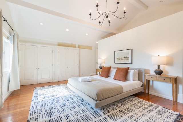 bedroom with lofted ceiling with beams, light wood-type flooring, a notable chandelier, and recessed lighting