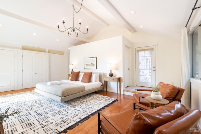 bedroom featuring recessed lighting, lofted ceiling with beams, an inviting chandelier, and wood finished floors