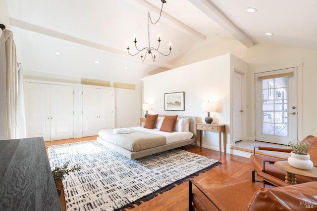 bedroom featuring two closets, vaulted ceiling with beams, a chandelier, recessed lighting, and wood finished floors