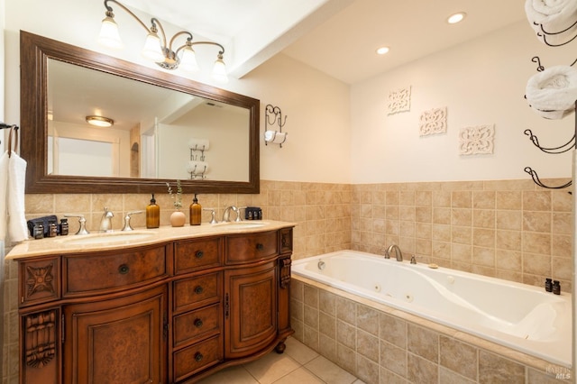 full bathroom featuring a sink, a tub with jets, double vanity, and tile patterned flooring