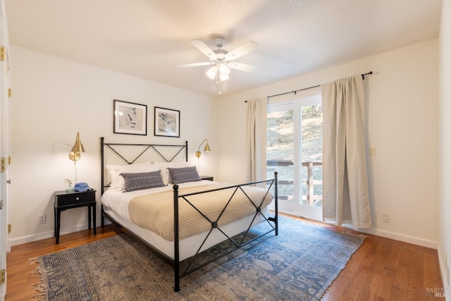 bedroom featuring a ceiling fan, baseboards, and wood finished floors