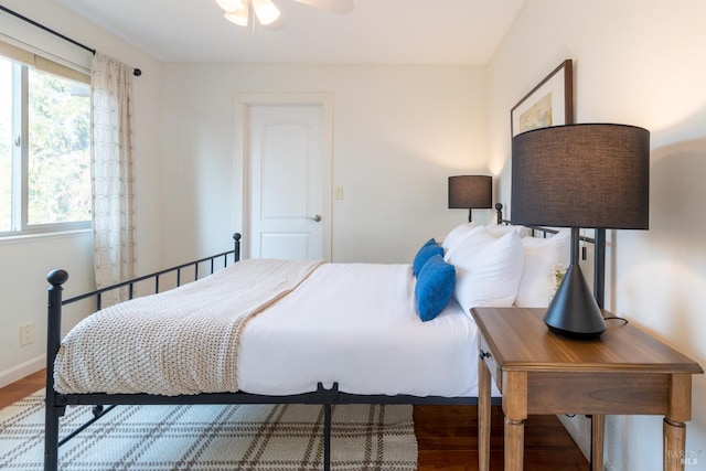 bedroom with wood finished floors and baseboards