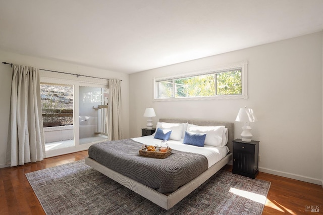 bedroom with access to outside, wood finished floors, and baseboards