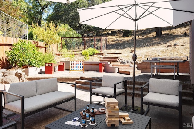 view of patio featuring an outdoor hangout area and fence