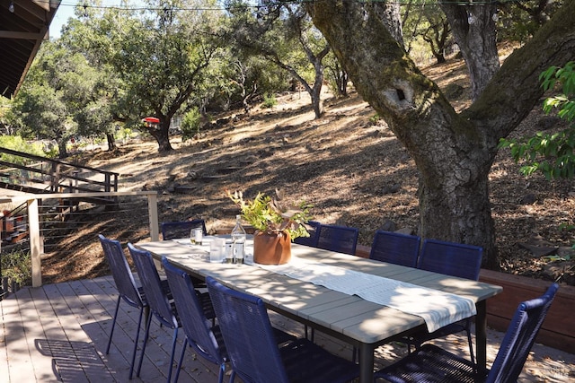 view of patio featuring outdoor dining space and a wooden deck