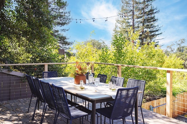 view of patio / terrace featuring a wooden deck and outdoor dining space