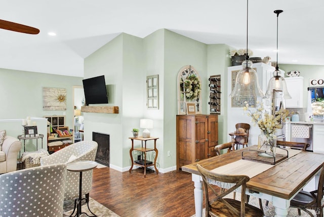 dining room featuring recessed lighting, baseboards, dark wood-style floors, and a fireplace