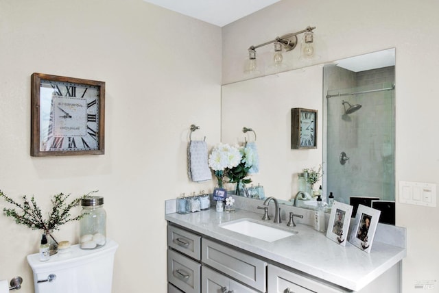 full bath featuring a tile shower, toilet, and vanity