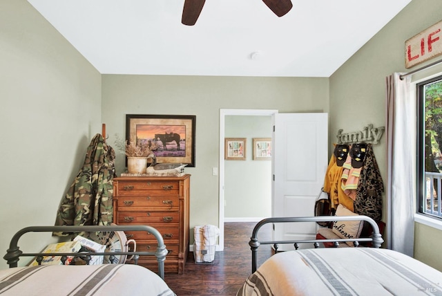 bedroom featuring ceiling fan, baseboards, and wood finished floors