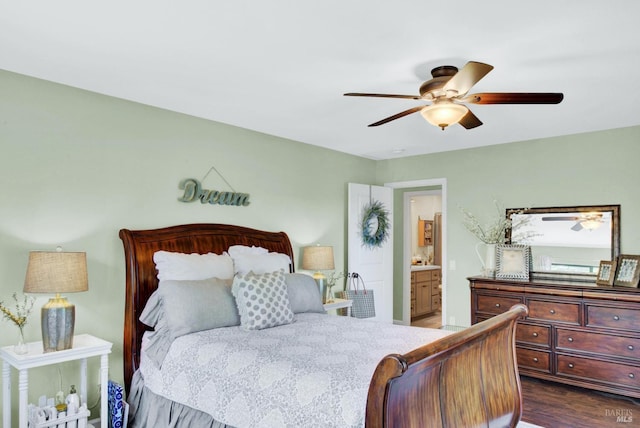 bedroom featuring ceiling fan, ensuite bath, and dark wood finished floors