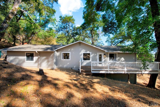 rear view of property featuring a deck