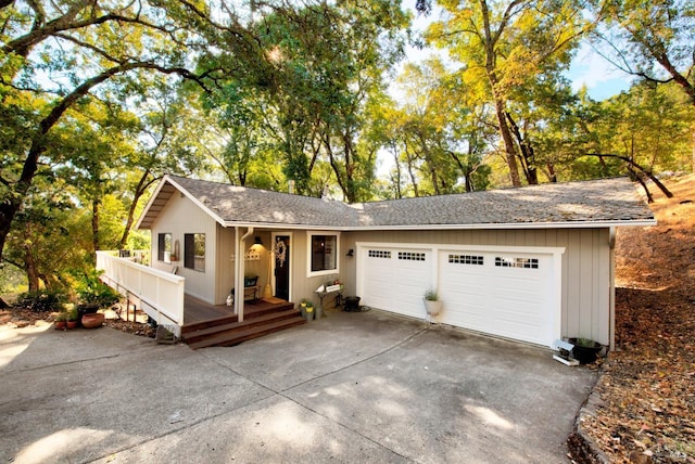 ranch-style house with an attached garage, roof with shingles, and driveway