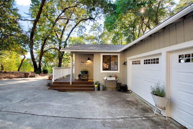 exterior space with a wooden deck, a garage, and driveway