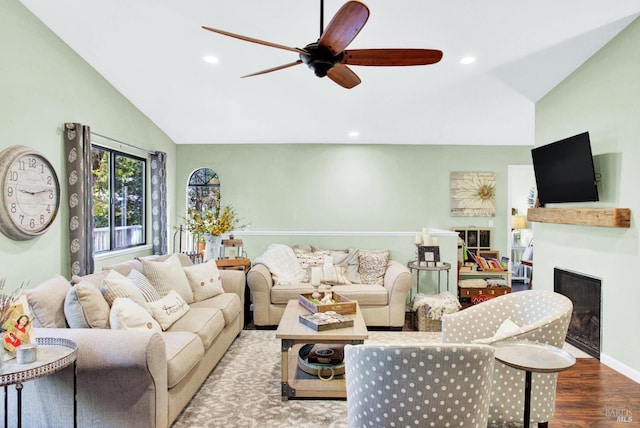 living room with a ceiling fan, a glass covered fireplace, wood finished floors, recessed lighting, and lofted ceiling