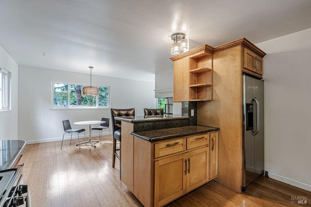 kitchen with open shelves, baseboards, light wood-style flooring, and stainless steel refrigerator with ice dispenser