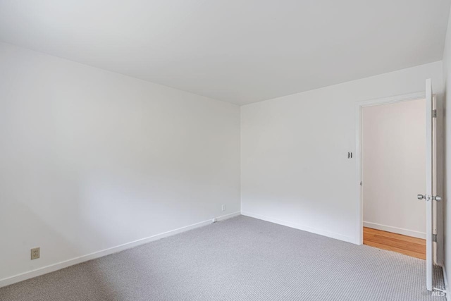 empty room with baseboards and carpet floors