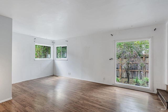 interior space with baseboards and wood finished floors