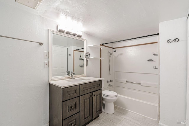 bathroom featuring toilet, vanity, a textured wall, a textured ceiling, and  shower combination