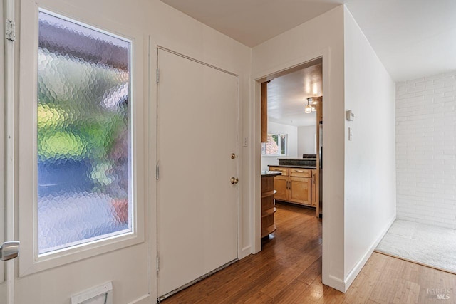 foyer with visible vents and wood finished floors