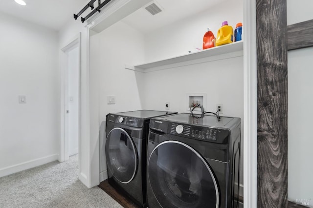 washroom with visible vents, independent washer and dryer, a barn door, carpet flooring, and laundry area