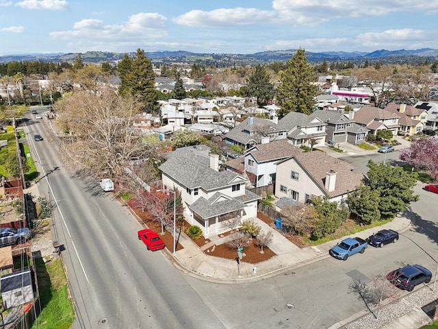 birds eye view of property with a mountain view and a residential view