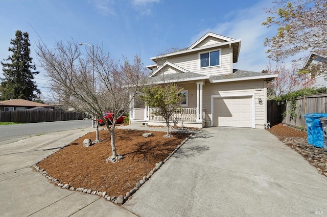 traditional home with covered porch, driveway, a garage, and fence