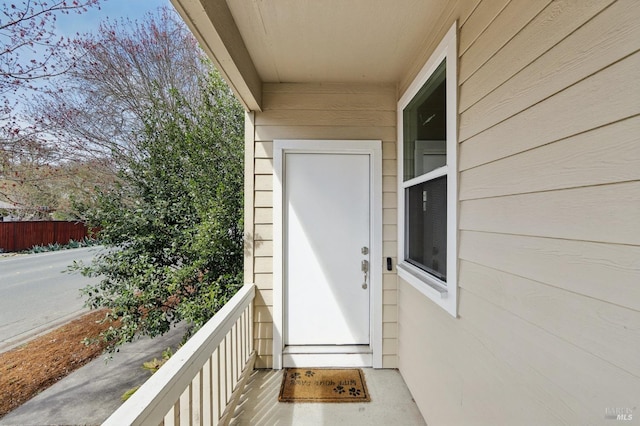 view of exterior entry featuring a balcony