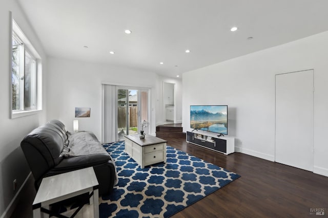 living room with recessed lighting and dark wood-style flooring