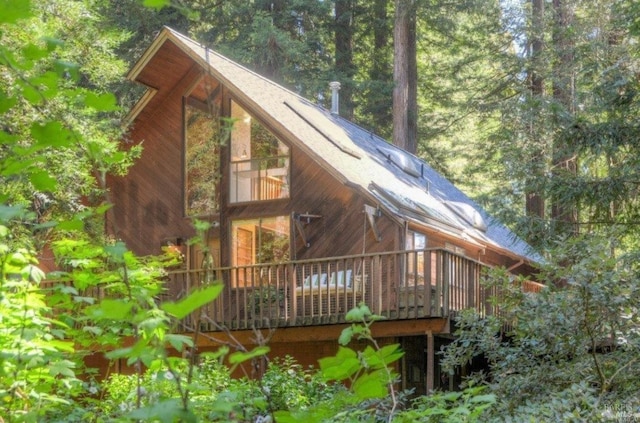 back of house featuring a wooden deck