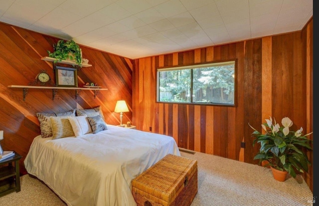 carpeted bedroom with wooden walls