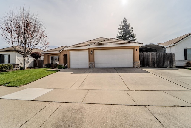 single story home with concrete driveway, a garage, fence, and a front yard