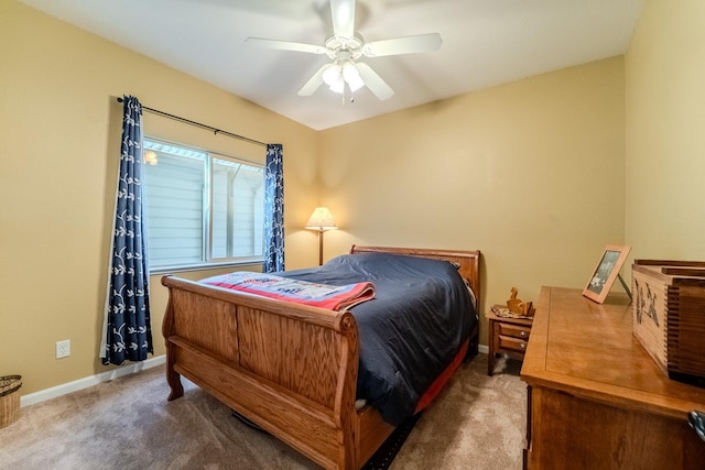 carpeted bedroom with baseboards and ceiling fan