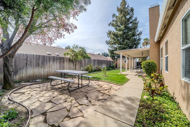 view of patio with outdoor dining space and a fenced backyard