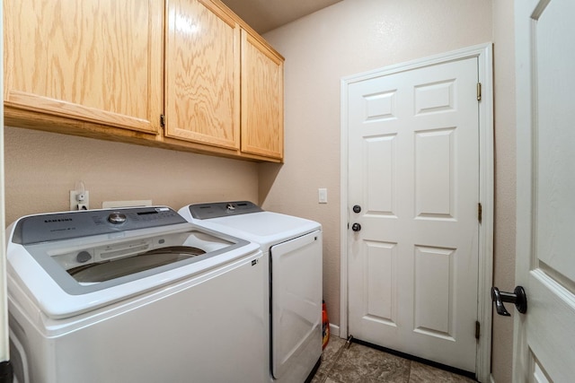 washroom with washer and dryer and cabinet space