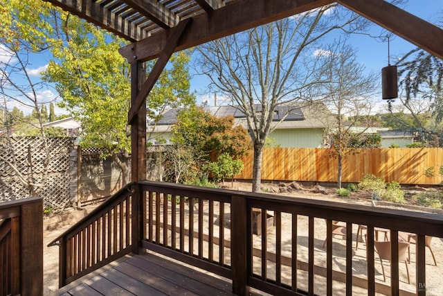 wooden deck featuring a fenced backyard and a pergola