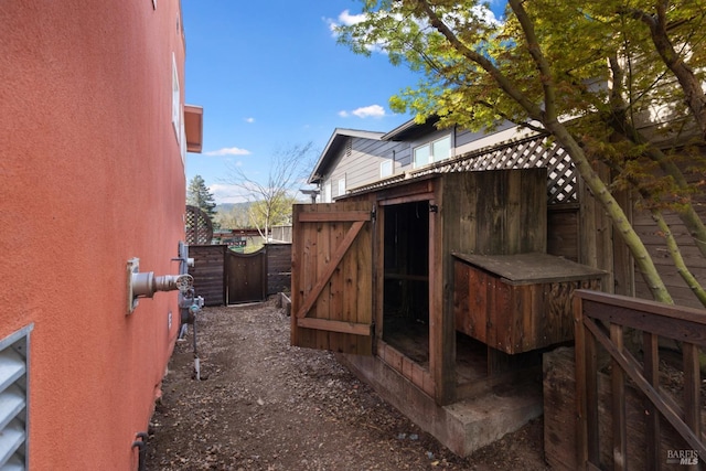 view of side of home featuring fence