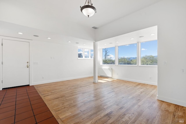 interior space featuring recessed lighting, visible vents, light wood-style flooring, and baseboards