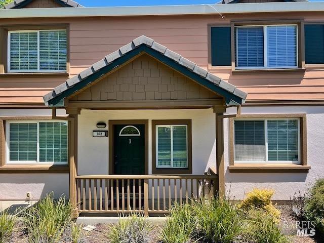 view of front of home with stucco siding and a porch