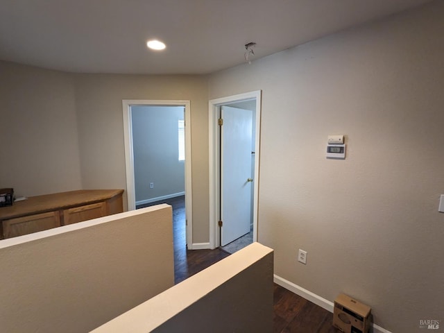 hallway with recessed lighting, baseboards, and dark wood-style floors