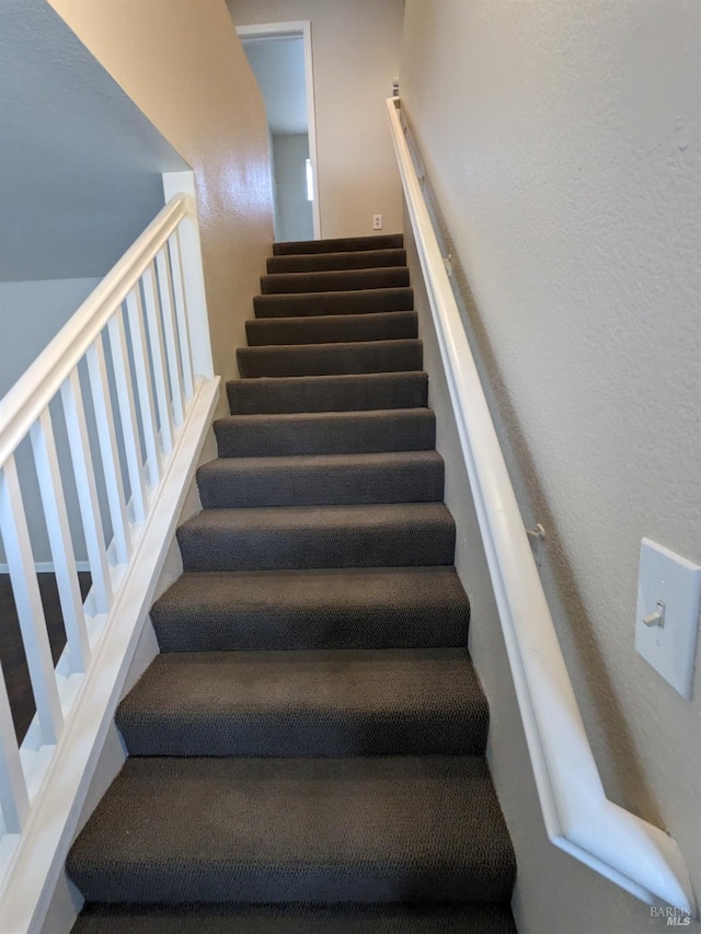 stairs with a textured wall