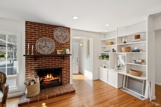 interior space with wood finished floors, a fireplace, and baseboards