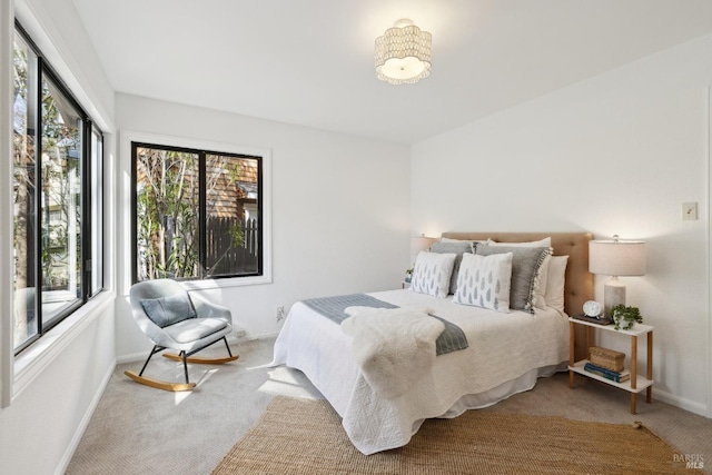 bedroom with baseboards and carpet floors