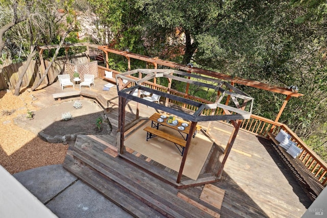 wooden terrace featuring fence