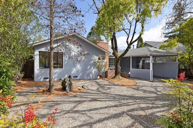 exterior space with crawl space, stucco siding, driveway, and fence