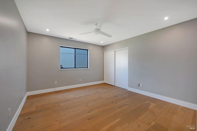 unfurnished bedroom with recessed lighting, a closet, baseboards, and light wood finished floors