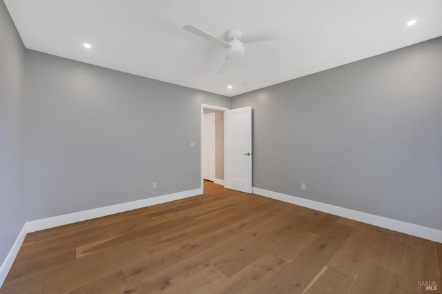 empty room featuring wood finished floors and baseboards