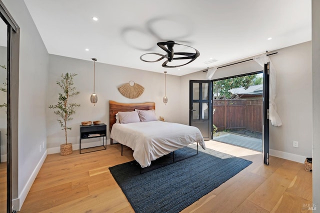 bedroom featuring recessed lighting, light wood-type flooring, baseboards, and access to exterior