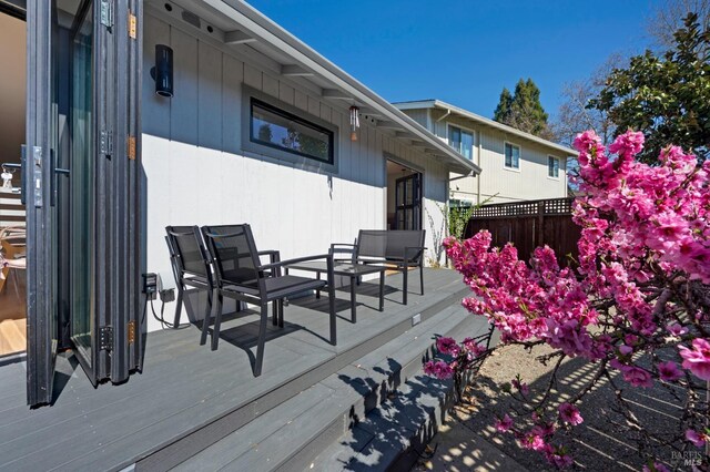 wooden terrace featuring fence