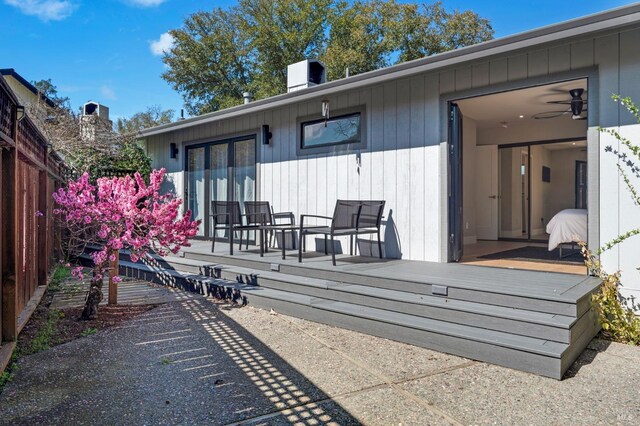 back of house featuring a wooden deck and fence