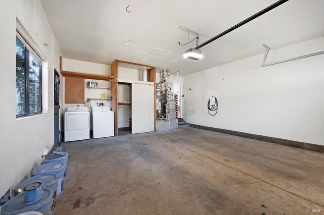 garage with washer and dryer, baseboards, and a garage door opener